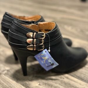 Elegant Black Heeled Boots with Gold Accents